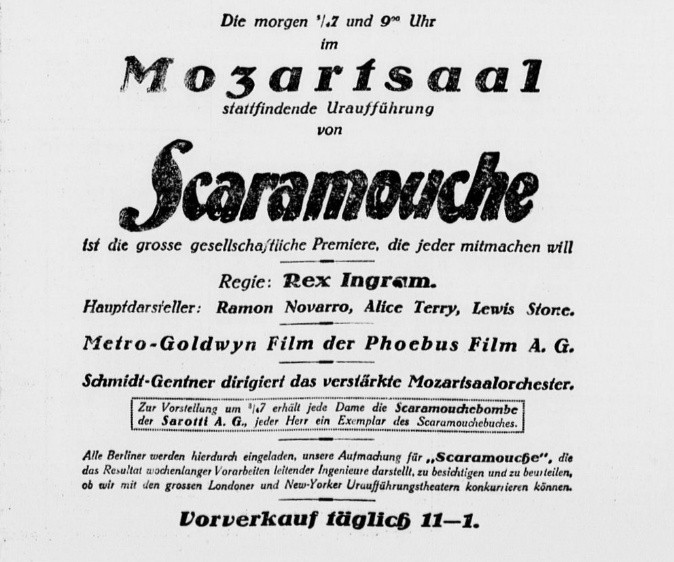 Newspaper advert in blackletter and bold type for the Mozartsaal premiere of Scaramouche, directed by Rex Ingram with Ramon Novarro, Alice Terry and Lewis Stone; one line reads "Schmidt-Gentner dirigiert das verstaerkte Mozartsaalorchester"